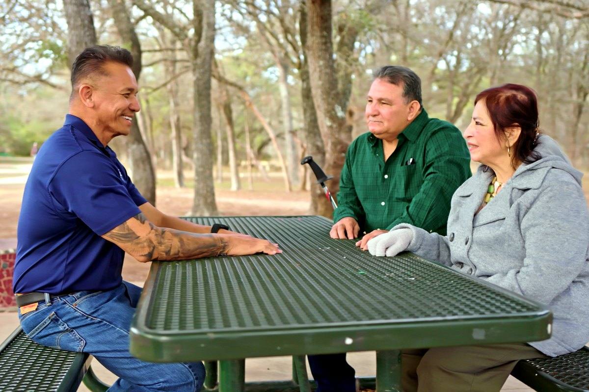Willie sitting with residents at a community table