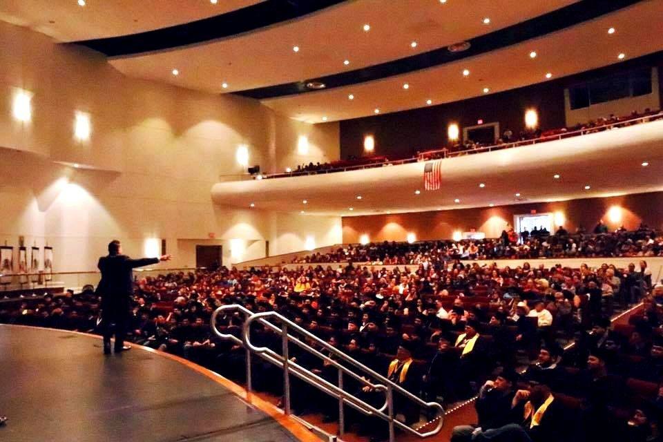 Willie speaking to a packed auditorium